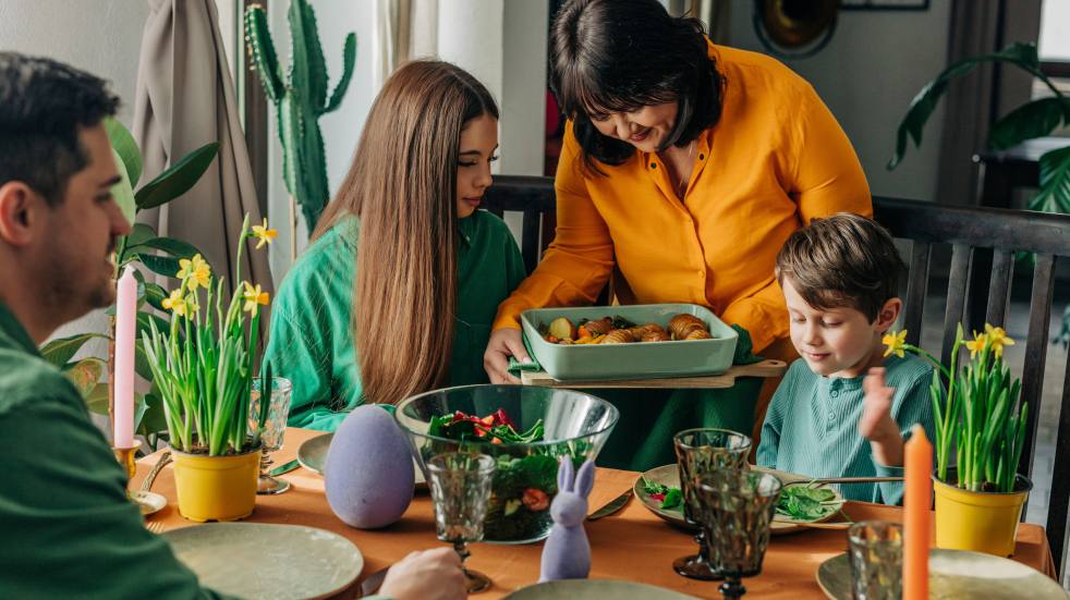 Woman serving dinner to family